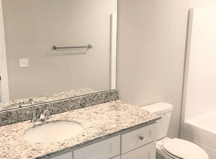 B3 (1-car) Master Bath with granite countertops, sink, toilet, and shower